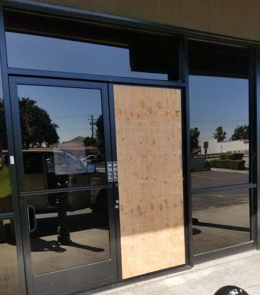 Board-up storefront to protect from damage, looting